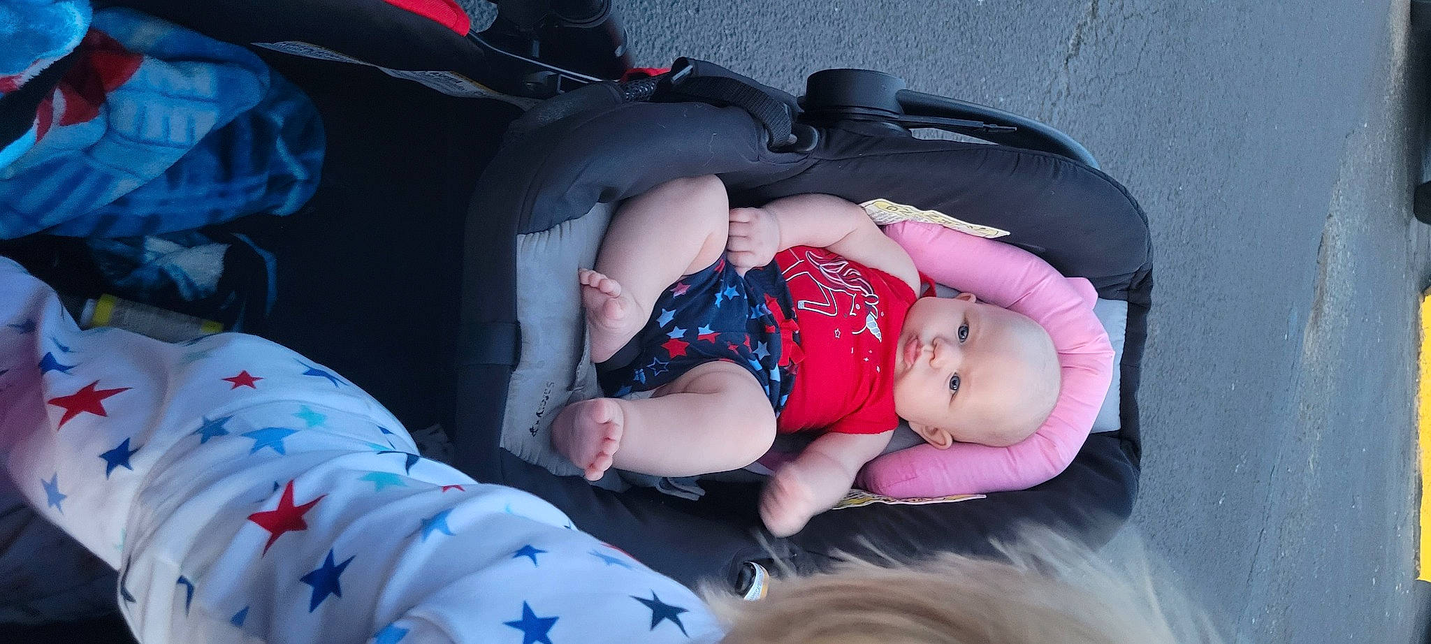 Dakoda is registered to the contest to win money with this photo: auto_part, baby, baby_carriage, baby_products, baby_sleeping, baby_toddler_clothing, car_seat, carmine, child, comfort, fun, grass, human_body, lap, leg, nap, pattern, person, sitting, textile