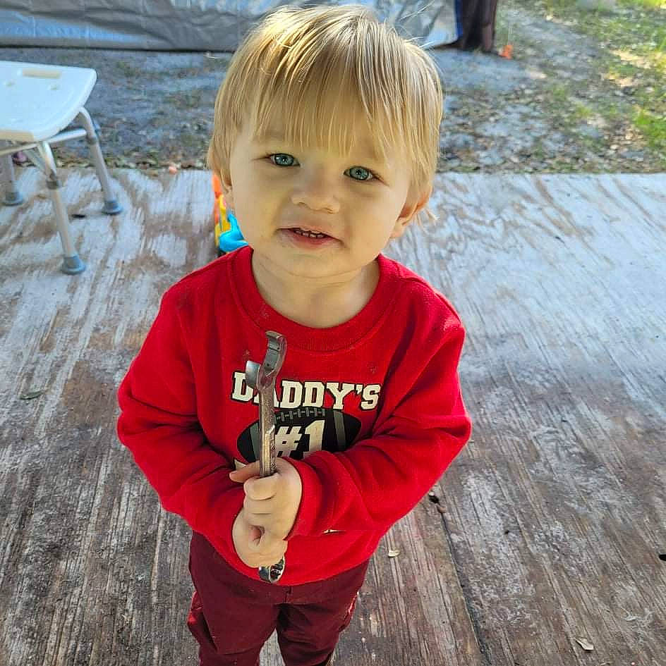 Teagan joined the competition — help win amazing prizes! baby_toddler_clothing, eye, face, hair, happy, head, iris, leaf, mammal, nose, people_in_nature, person, plant, skin, sleeve, smile, standing, toddler, tree, water