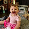 baby, child, smiling, pink_dress, blue_eyes, indoor, bed, crib, furniture, curly_hair, cute, happy, person, portrait, toddler, room, blanket, tissue, cozy, hair_buns