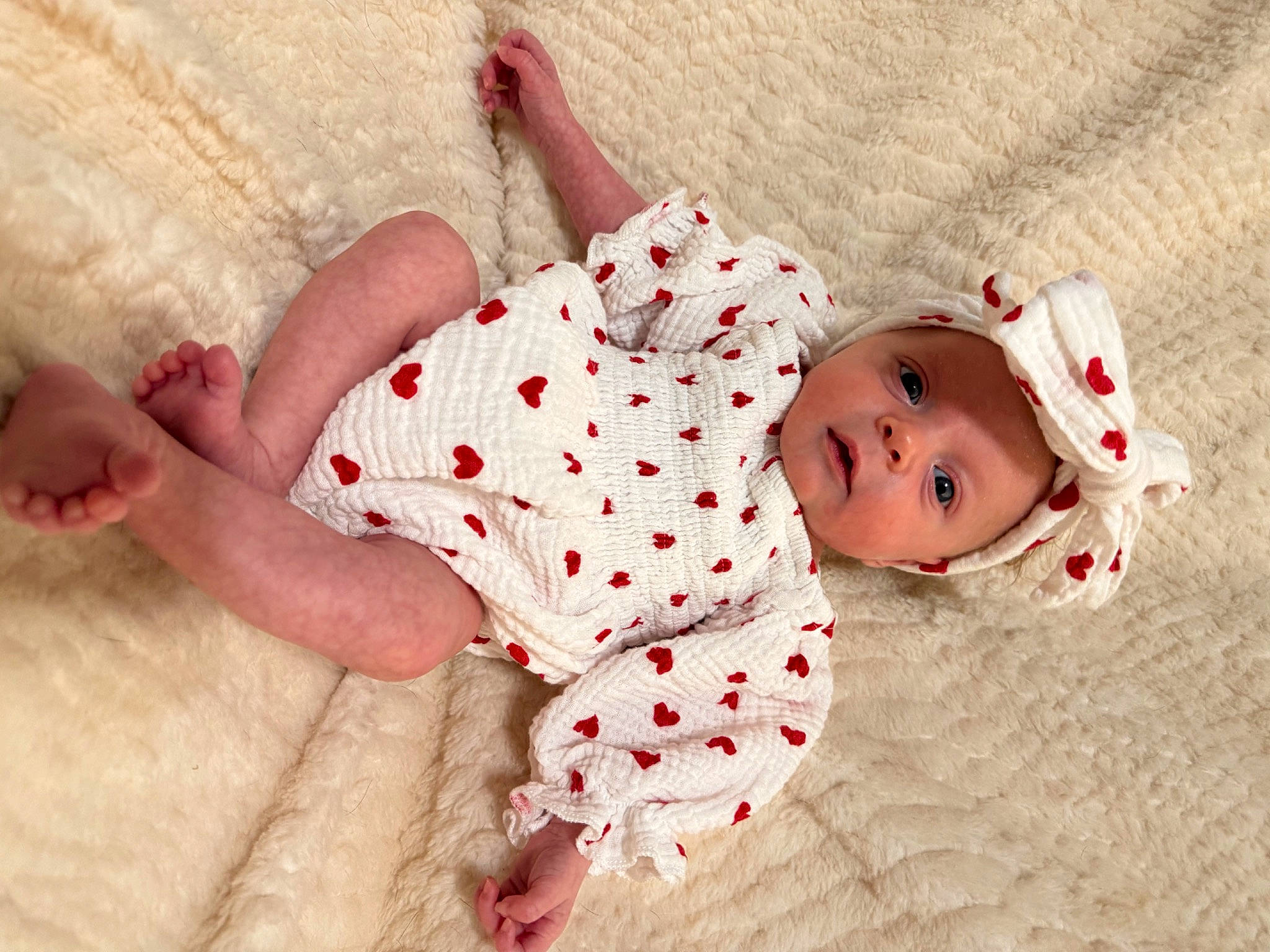 Oaklee is registered to the contest to win money with this photo: baby, baby_toddler_clothing, child, comfort, foot, head, headwear, human_body, human_leg, knee, leg, linens, mammal, pattern, person, pink, skin, sleeve, textile, thigh