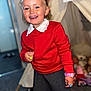 Paisley joined the competition — help win amazing prizes! child, girl, smile, red_sweater, grey_skirt, rings, watch, indoor, tent, plush_toys, happy, curly_hair, playful, face, person, carpet, accessories, collar, candid, portrait