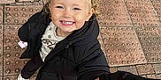 Paisley is registered to the contest to win money with this photo: child, smile, holding_hands, outdoor, pavement, black_jacket, blonde_hair, pigtails, happy, person, footwear, casual_clothing, urban, hand, cute, joy, young, portrait, walking, daylight
