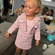Paisley is registered to the contest to win money with this photo: child, girl, pink_clothing, plaid, socks, indoor, couch, floor, balloon, people, family, party, shoes, curly_hair, smile, portrait, living_room, furniture, casual, happy