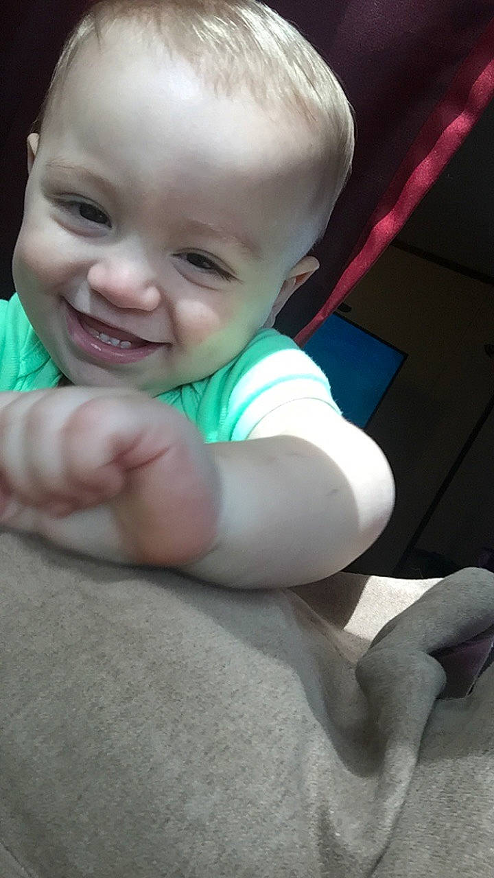 Kurtis is registered to the contest to win money with this photo: baby, cheek, child, eye, face, facial_expression, finger, hand, head, joy, lip, mouth, nose, person, skin, smile, toddler, tummy_time