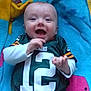 baby, ball, clothing, cushion, face, football, furniture, happy, head, homedecor, laughing, pants, person, photography, portrait, quilt, shirt, soccer, soccerball, t_shirt