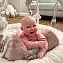 baby, infant, smiling, play_mat, plush_toy, soft_toys, pink_clothing, face, hand, floor, sofa, window, wooden_floor, indoor, child, cute, happy, crawling, head, furniture