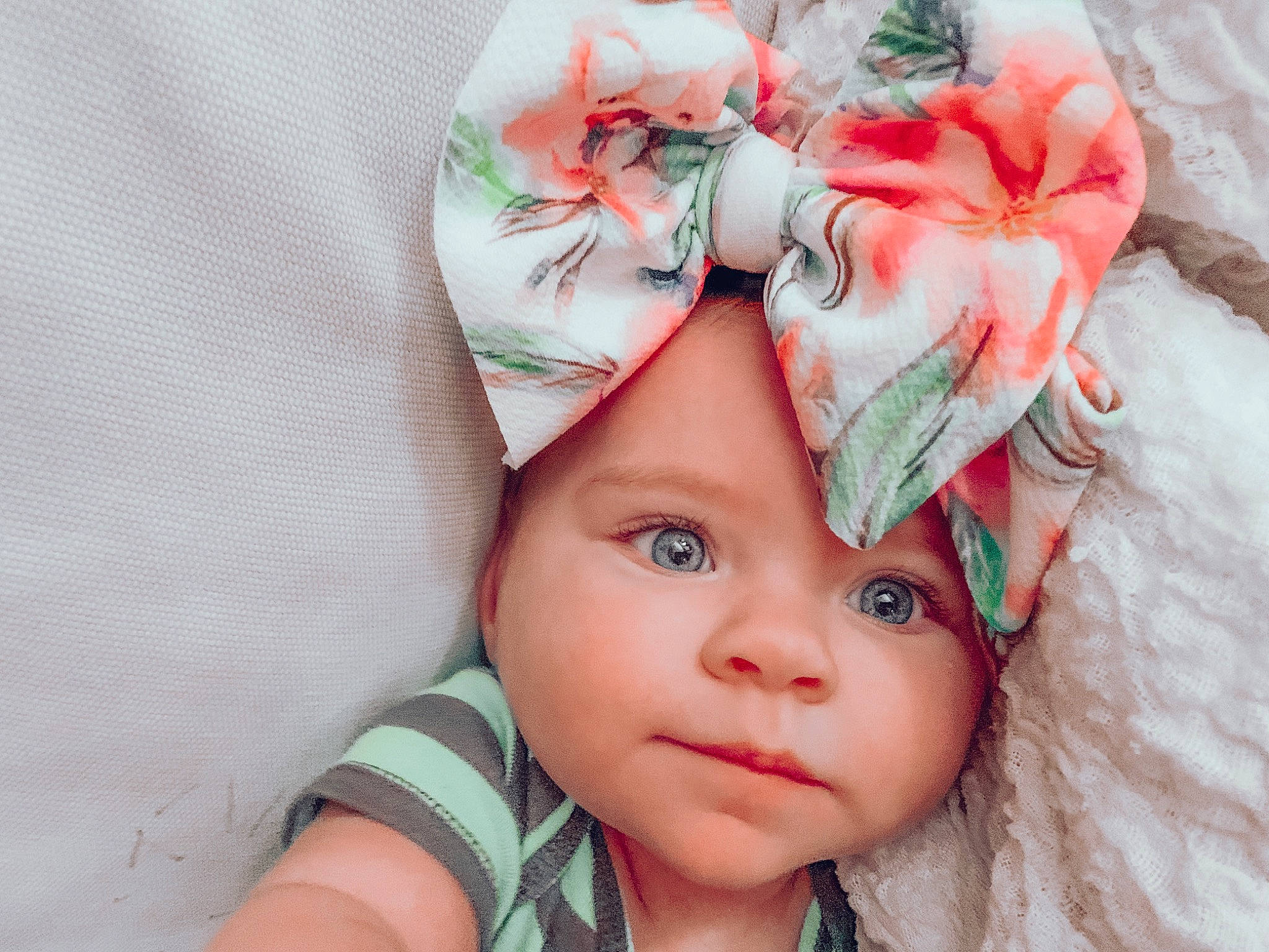 Hallie is registered to the contest to win money with this photo: baby, bonnet, cap, child, clothing, fashion_accessory, hair_accessory, hat, head, headgear, headwear, person, pink, plant, toddler