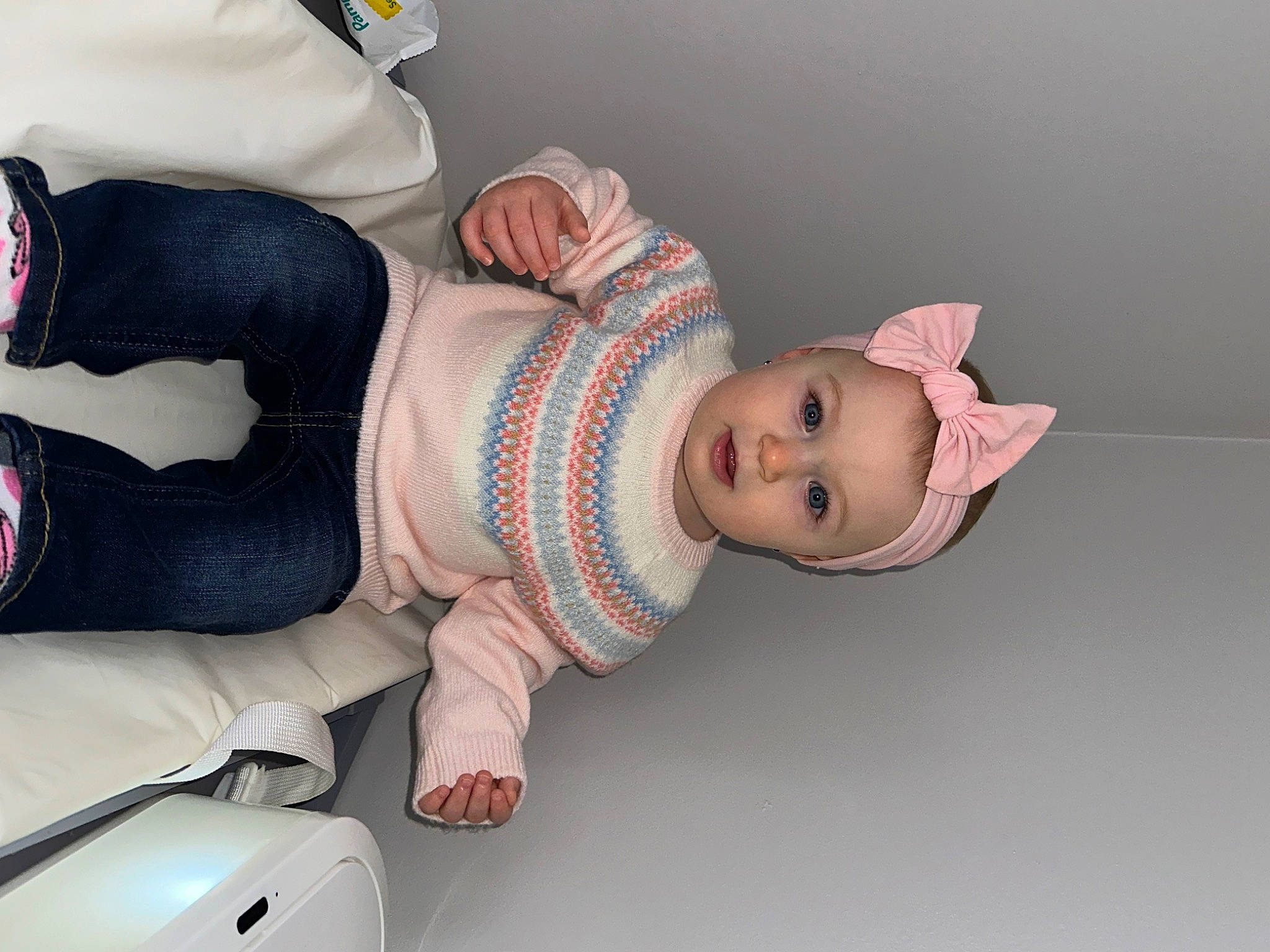 Myla is registered to the contest to win money with this photo: arm, baby, baby_products, baby_safety, baby_toddler_clothing, child, comfort, finger, hand, human_body, human_leg, joint, knee, leg, person, pink, product, sleeve, sock, thigh