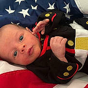 Maverick joined the competition — help win amazing prizes! american_flag, baby, black_outfit, clothing, cute, eyes, face, flag, hand, infant, lying_down, newborn, person, portrait, red, skin, small, stars, stripes, white