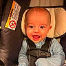 Maverick is registered to the contest to win money with this photo: baby, baby_boy, baby_girl, blue_clothing, car_seat, child, closeup, cute, happiness, head_support, indoor, infant, mittens, person, portrait, safety, seatbelt, smiling, soft_lighting, young_child
