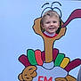 Frankie is registered to the contest to win money with this photo: child, face_cutout, smiling, outdoor, turkey, cartoon, colorful, greenery, festive, holiday, playful, portrait, young_child, happy, red_clothing, nature, fun, background, headshot, cutout_board