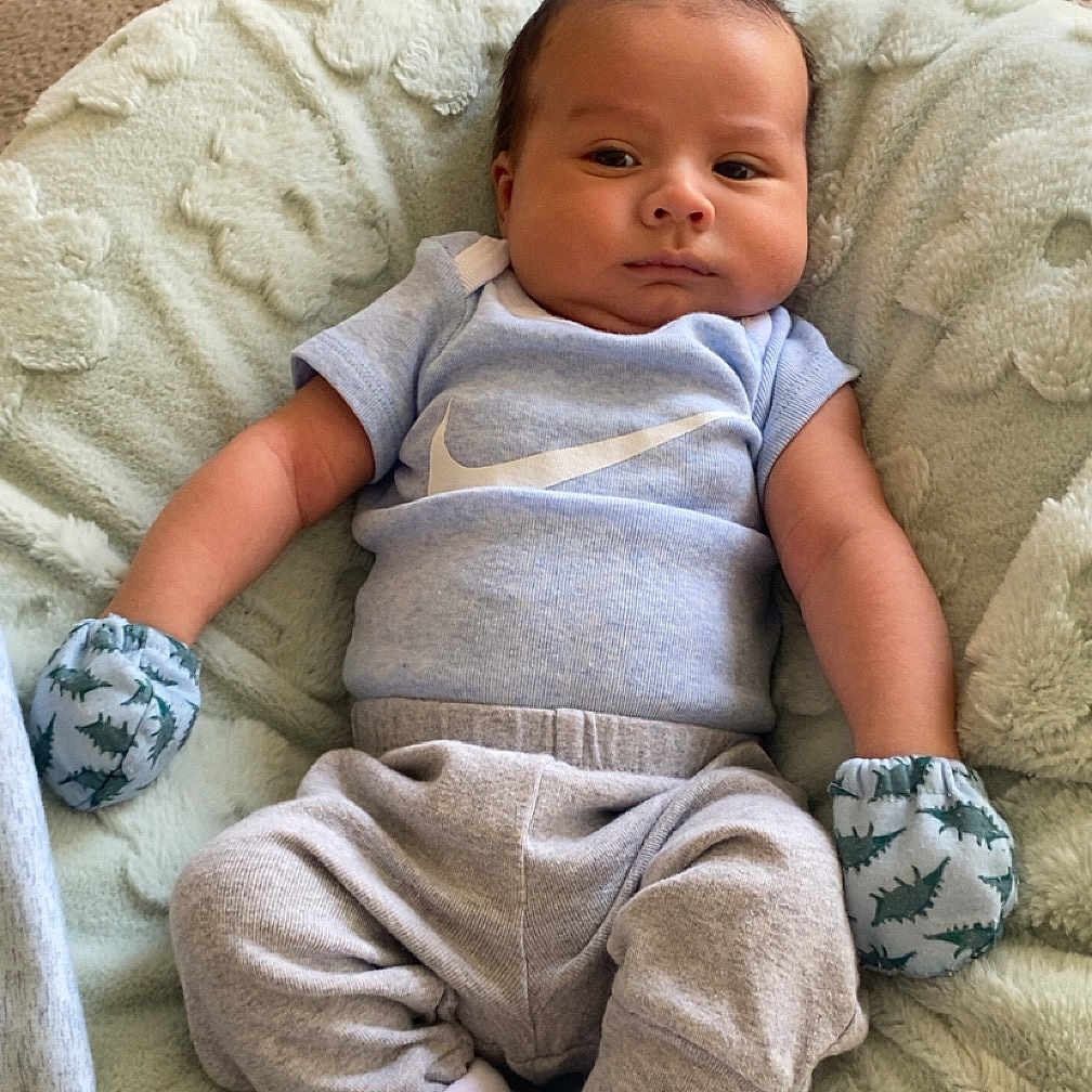 Mato is registered to the contest to win money with this photo: baby, bed, blanket, clothing, couch, cushion, face, furniture, glove, head, homedecor, hosiery, linen, newborn, pants, person, photography, portrait, quilt, sock