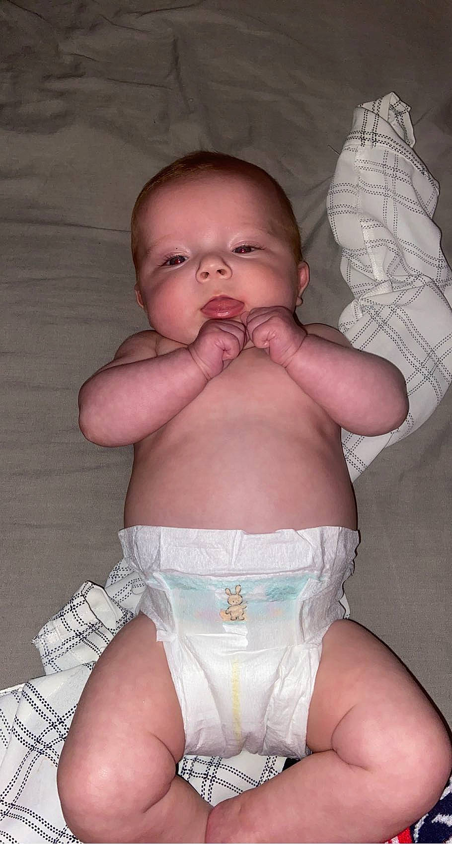 Nova is registered to the contest to win money with this photo: arm, baby, baby_toddler_clothing, cheek, chest, comfort, eye, finger, hand, head, human_body, iris, lip, mouth, muscle, person, pink, skin, stomach, thigh