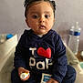 Maryam participe au concours pour gagner de l'argent avec cette photo : baby, child, pigtails, navy_blue_hoodie, text_on_clothing, sitting, holding, cream_tube, small_bottle, indoors, water_bottle, blurred_background, face, eyes, hands, casual_clothing, cute, person, portrait, young_child