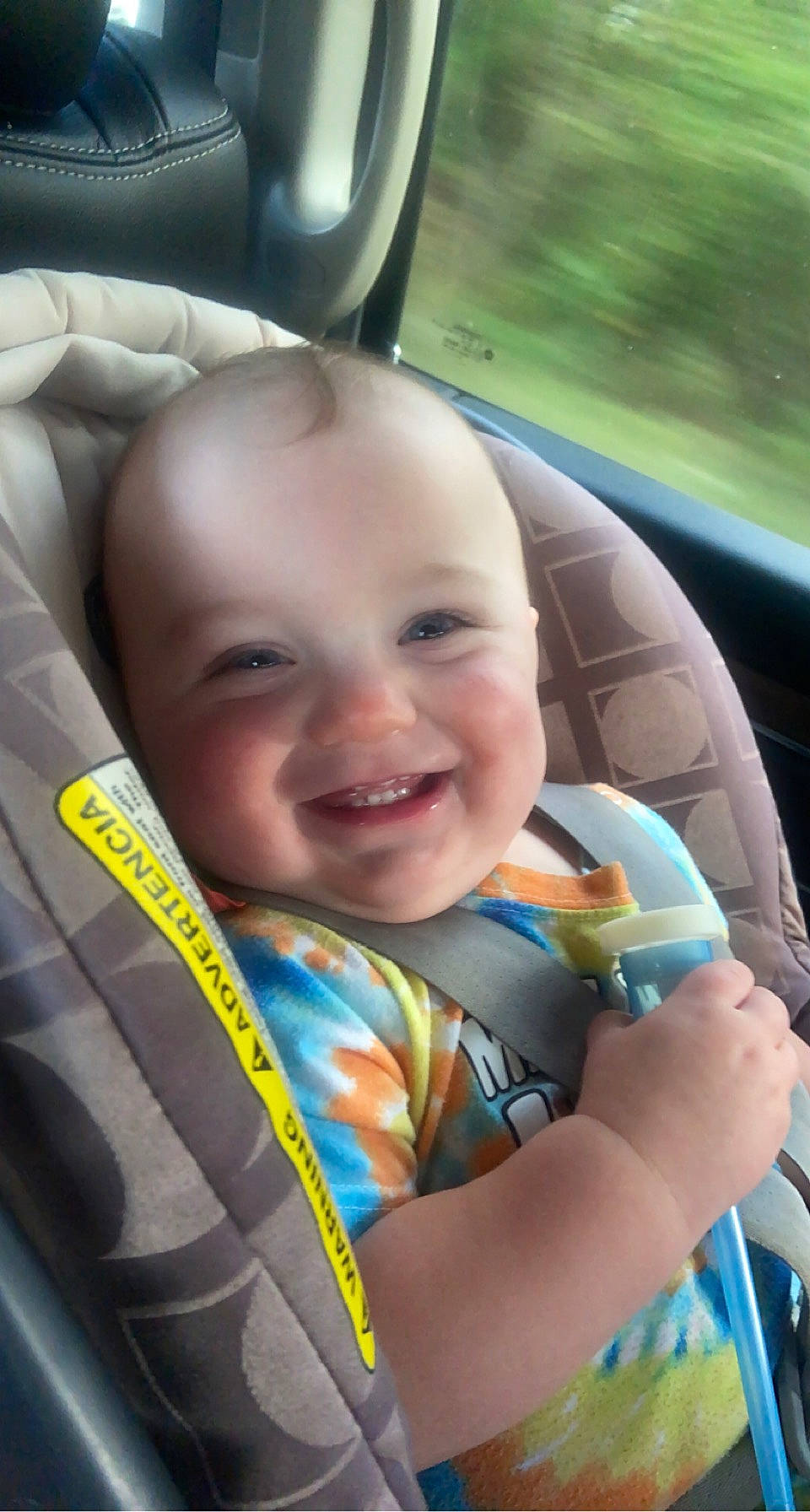 Tyson is registered to the contest to win money with this photo: auto_part, baby, baby_carriage, car_seat, child, comfort, cool, face, fun, grass, happy, joy, leisure, motor_vehicle, people, person, plant, skin, smile, toddler