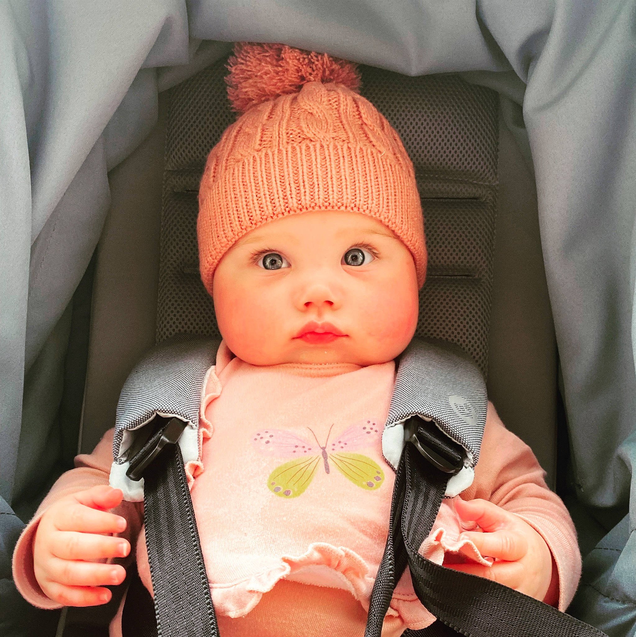 Beatrice joined the competition — help win amazing prizes! baby, baby_carriage, baby_toddler_clothing, cap, cheek, chin, comfort, cool, eyebrow, face, finger, hand, head, headwear, lip, mouth, nose, outerwear, person, pink