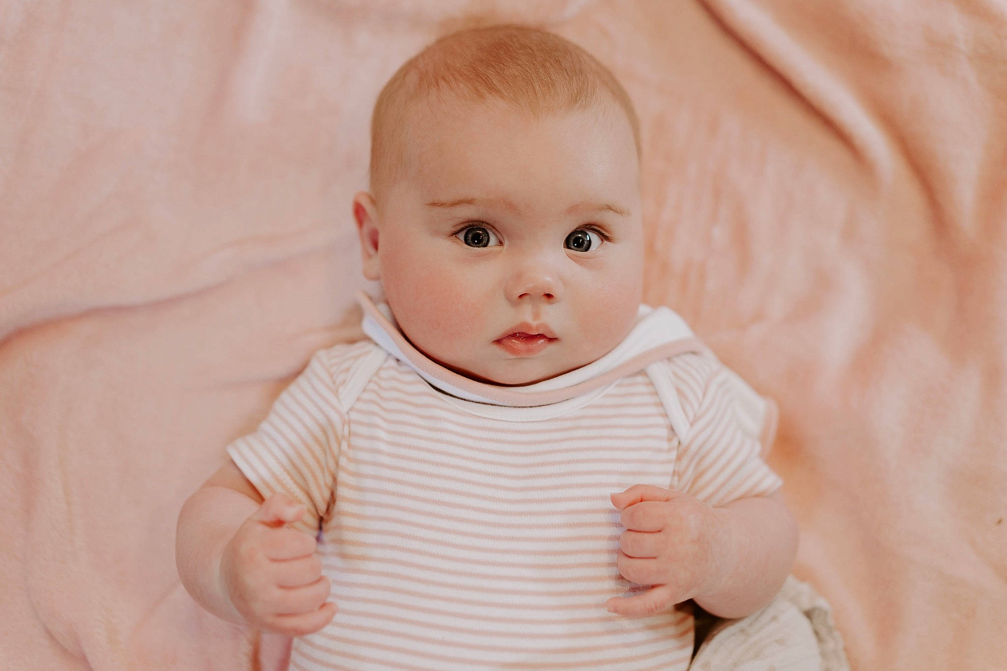 Beatrice joined the competition — help win amazing prizes! arm, baby, baby_toddler_clothing, cheek, child, collar, comfort, facial_expression, gesture, happy, head, iris, lip, nose, person, pink, sitting, skin, sleeve, thumb