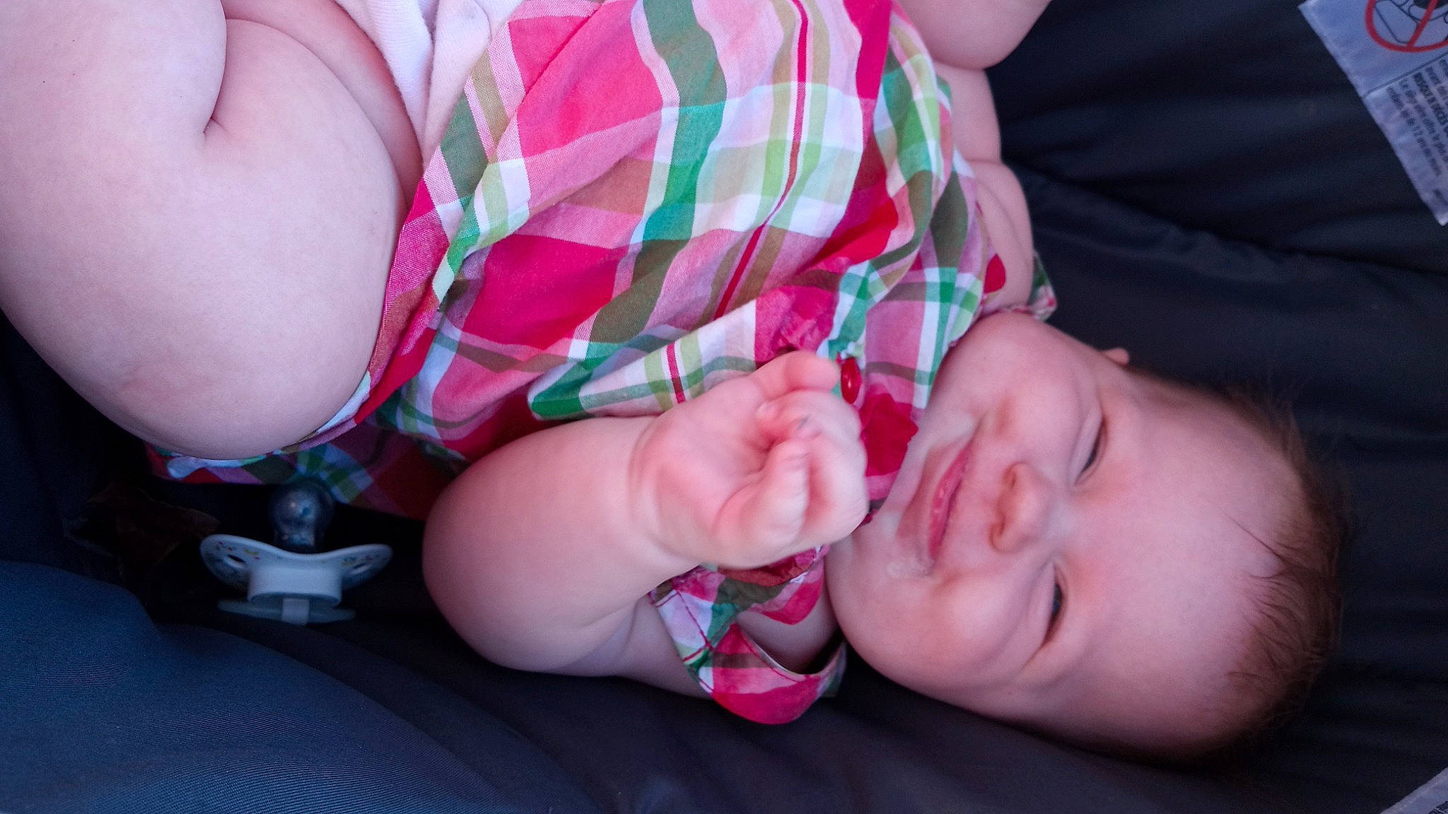 Angel is registered to the contest to win money with this photo: arm, baby, baby_toddler_clothing, cheek, comfort, eye, eyelash, finger, gesture, grass, hand, happy, lip, mouth, nail, nose, person, pink, skin, thumb