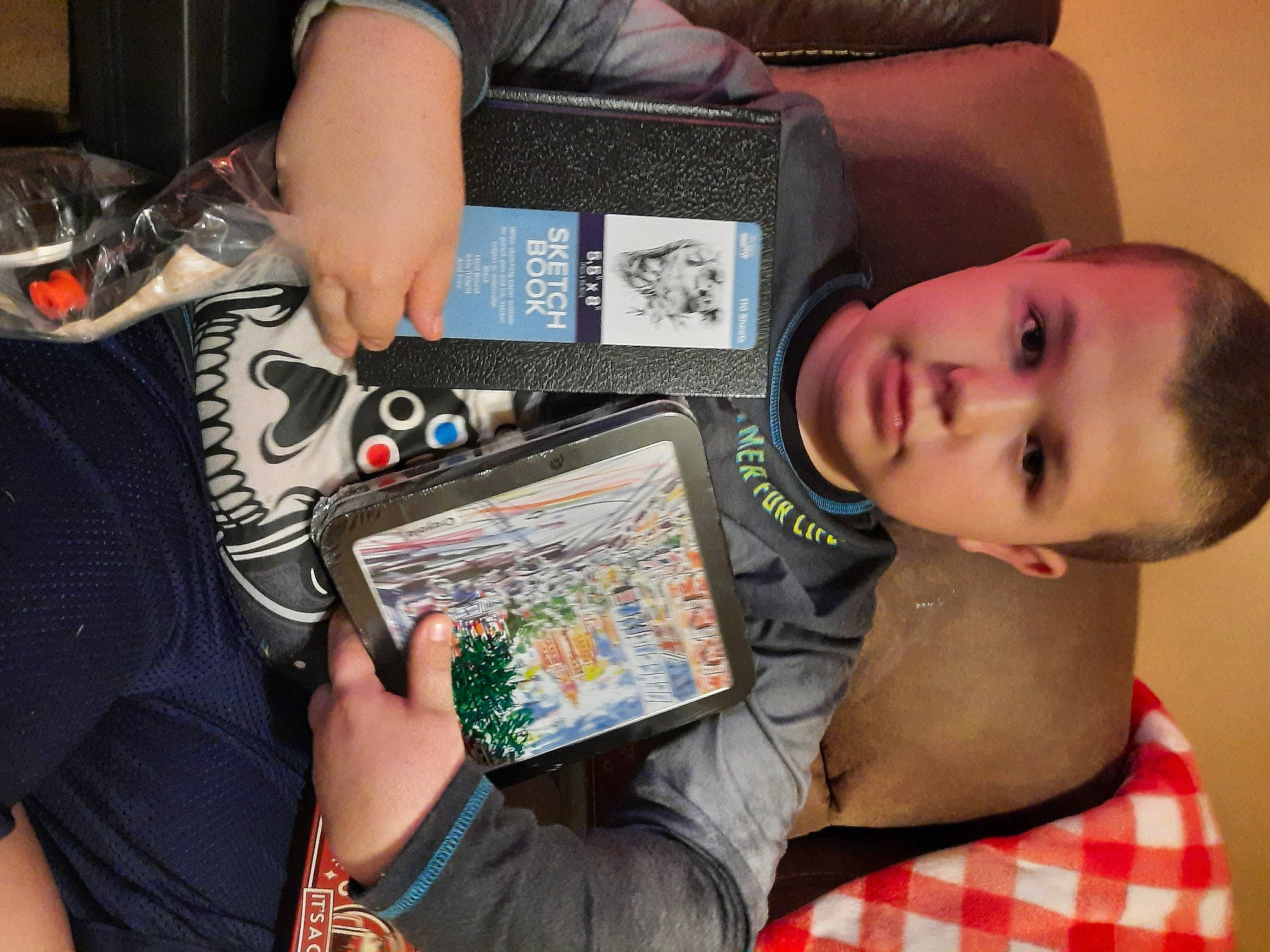 Randy is registered to the contest to win money with this photo: art, child, comfort, finger, fun, gadget, hand, learning, leisure, nail, pattern, person, play, recreation, room, sharing, t_shirt, toddler, toy, visual_arts