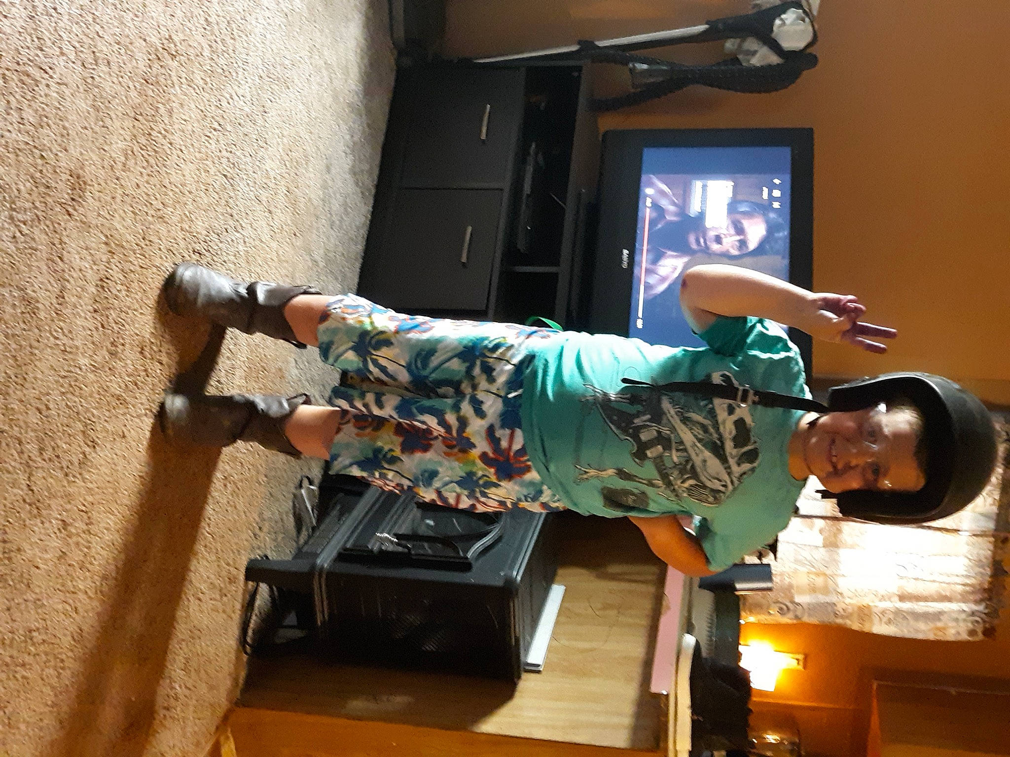 Randy is registered to the contest to win money with this photo: art, balance, display_device, door, elbow, flooring, fun, hardwood, human_leg, joy, machine, person, room, television, television_set, wood, wrist