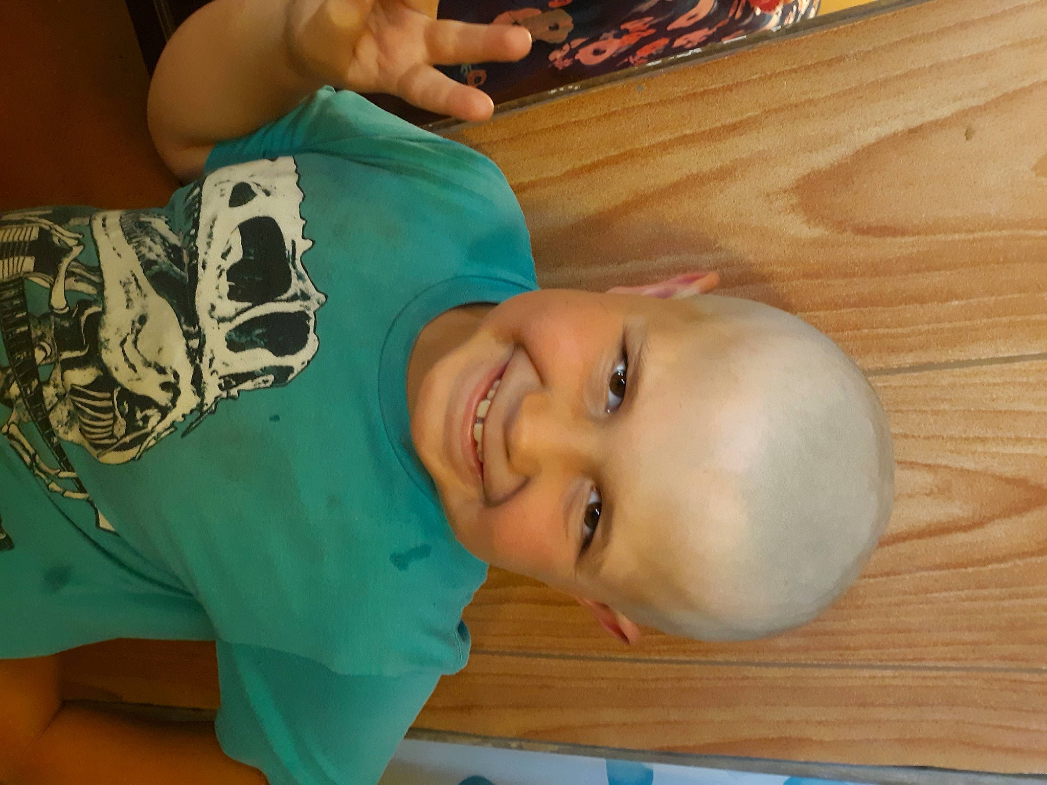 Randy is registered to the contest to win money with this photo: arm, baby_toddler_clothing, cheek, chest, elbow, eyebrow, flooring, fun, happy, hardwood, hat, joy, mouth, neck, nose, person, smile, t_shirt, toddler, varnish