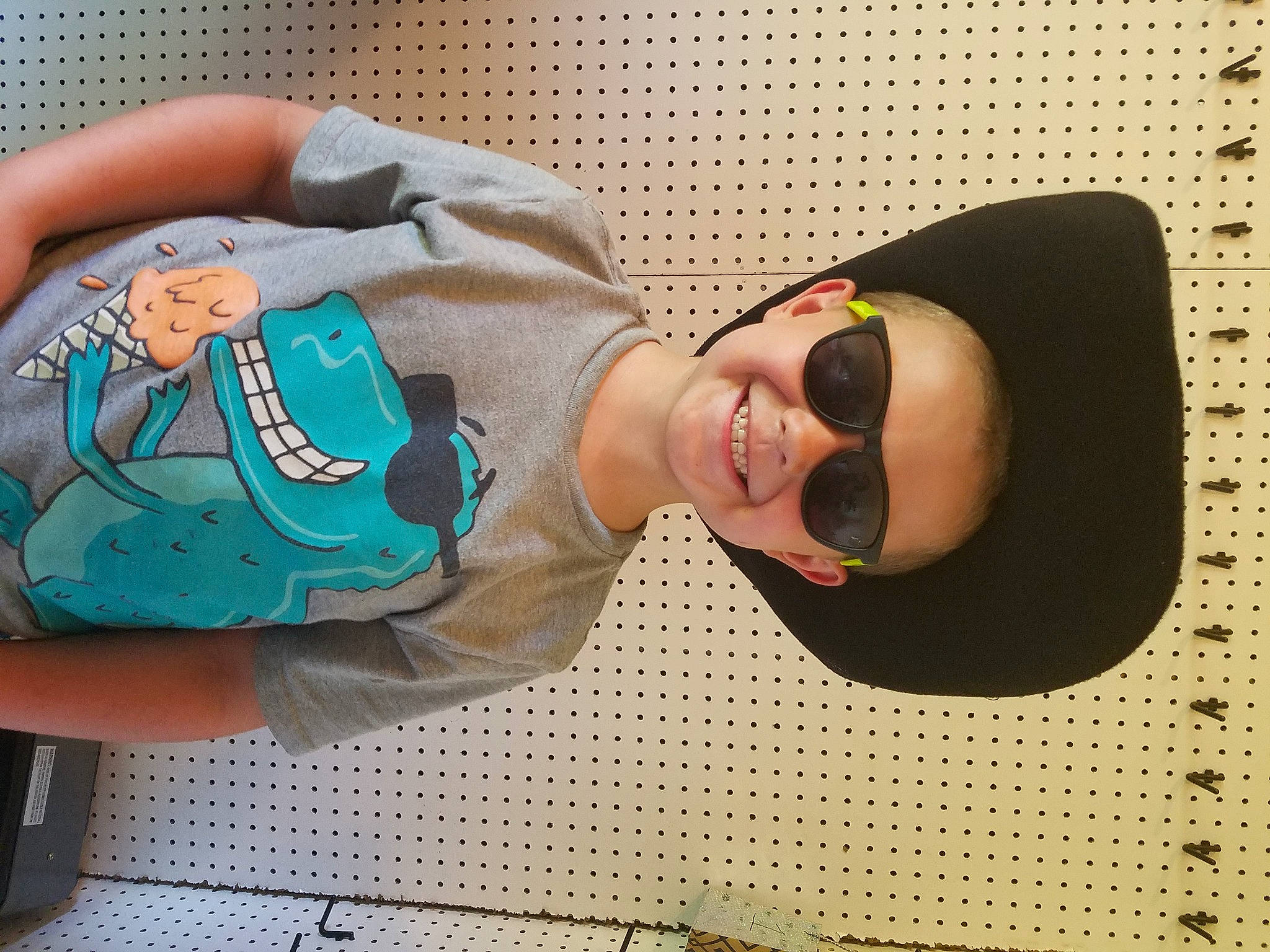 Randy is registered to the contest to win money with this photo: baby, baby_toddler_clothing, comfort, cool, elbow, eyewear, finger, goggles, happy, hat, human_body, joy, nail, pattern, person, sleeve, smile, sunglasses, thigh, toddler