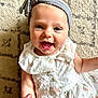 baby, child, smiling, headband, dress, hand, finger, carpet, pattern, blue_eyes, cute, happy, infant, person, portrait, indoors, skin, clothing, small_child, holding