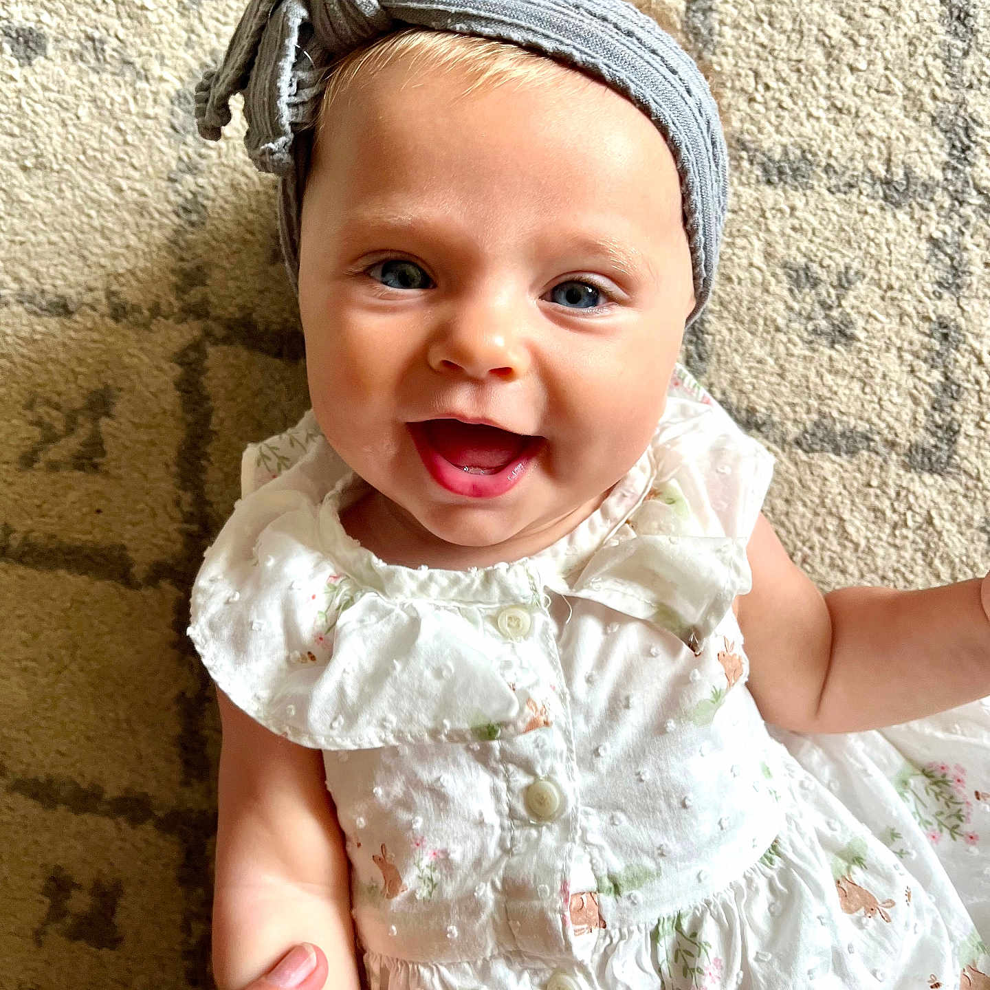 Loretta joined the competition — help win amazing prizes! baby, blue_eyes, carpet, child, clothing, cute, dress, finger, hand, happy, headband, holding, indoors, infant, pattern, person, portrait, skin, small_child, smiling