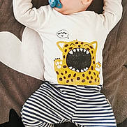 Milo participe au concours pour gagner de l'argent avec cette photo : baby, sleeping, pacifier, white_shirt, cat_graphic, striped_pants, blanket, stars, heart, infant, cozy, cute, child, resting, soft_toys, footwear, smiling_cat, patterned_clothing, indoors, peaceful