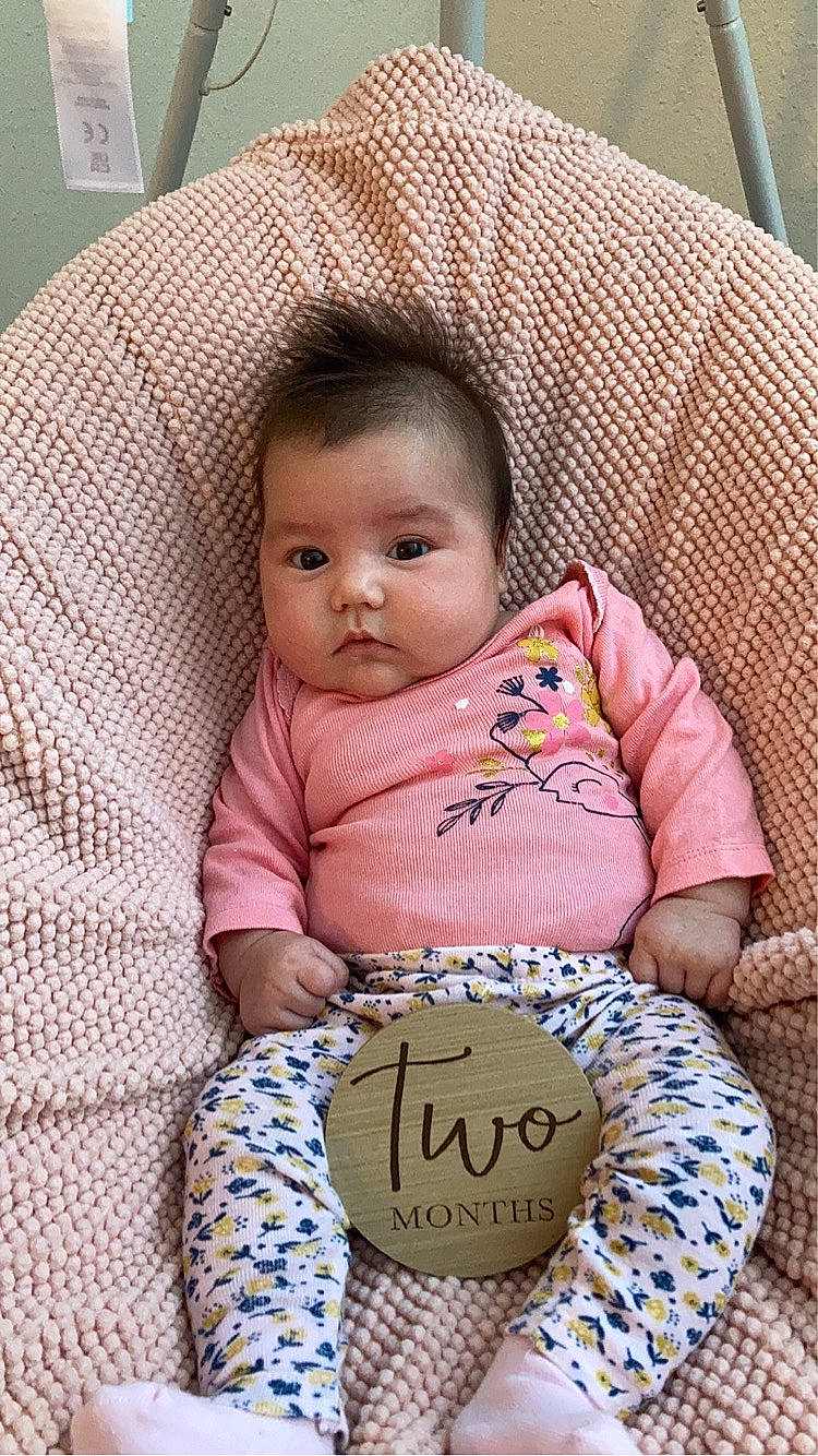 Parker is registered to the contest to win money with this photo: baby, baby_products, baby_toddler_clothing, bib, cheek, child, chin, comfort, happy, iris, linens, lip, nose, pattern, person, sitting, skin, sleeve, t_shirt, textile