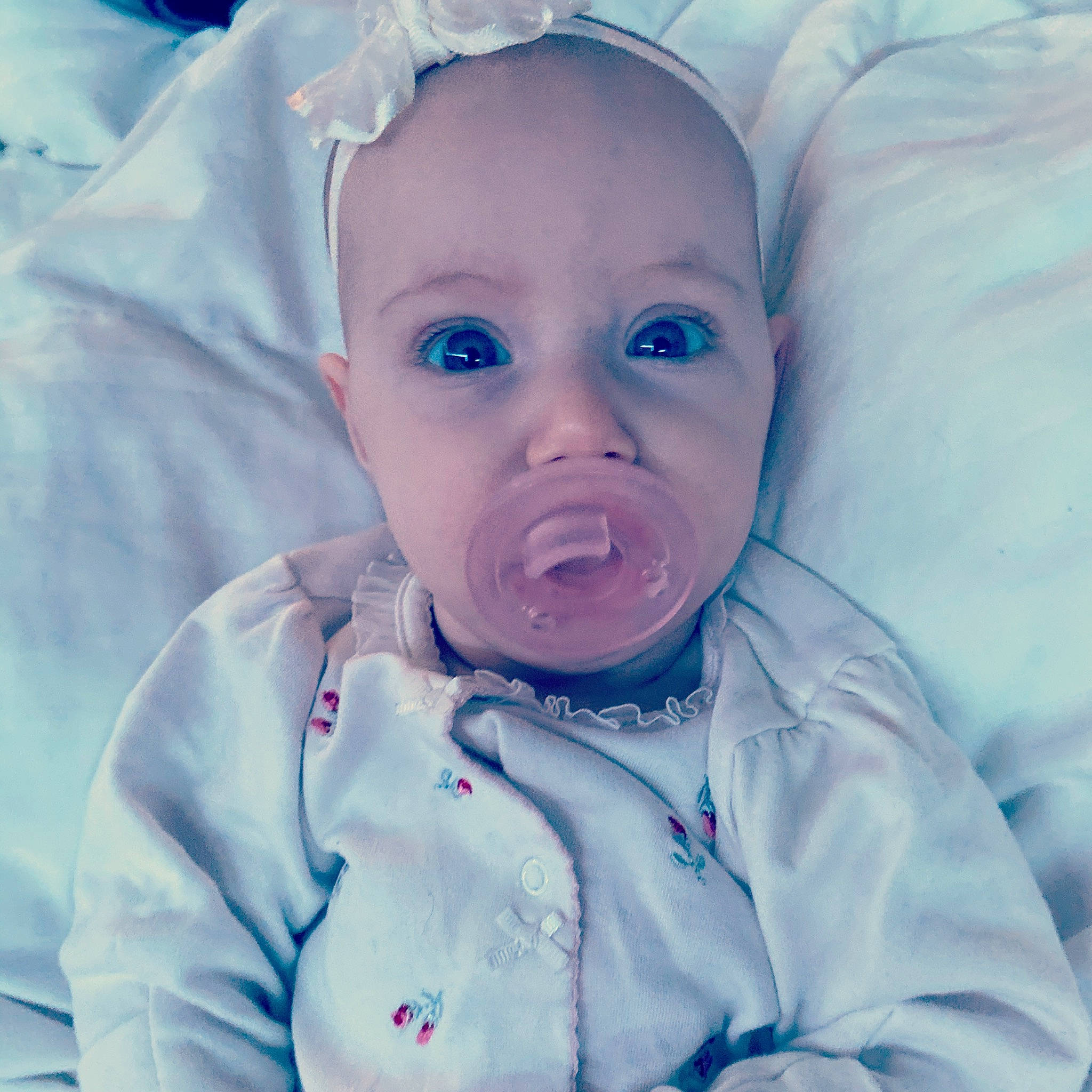 Ella is registered to the contest to win money with this photo: baby, baby_making_funny_faces, blue, cheek, child, ear, eye, face, facial_expression, head, human, iris, lip, mouth, nose, organ, person, photography, skin, smile