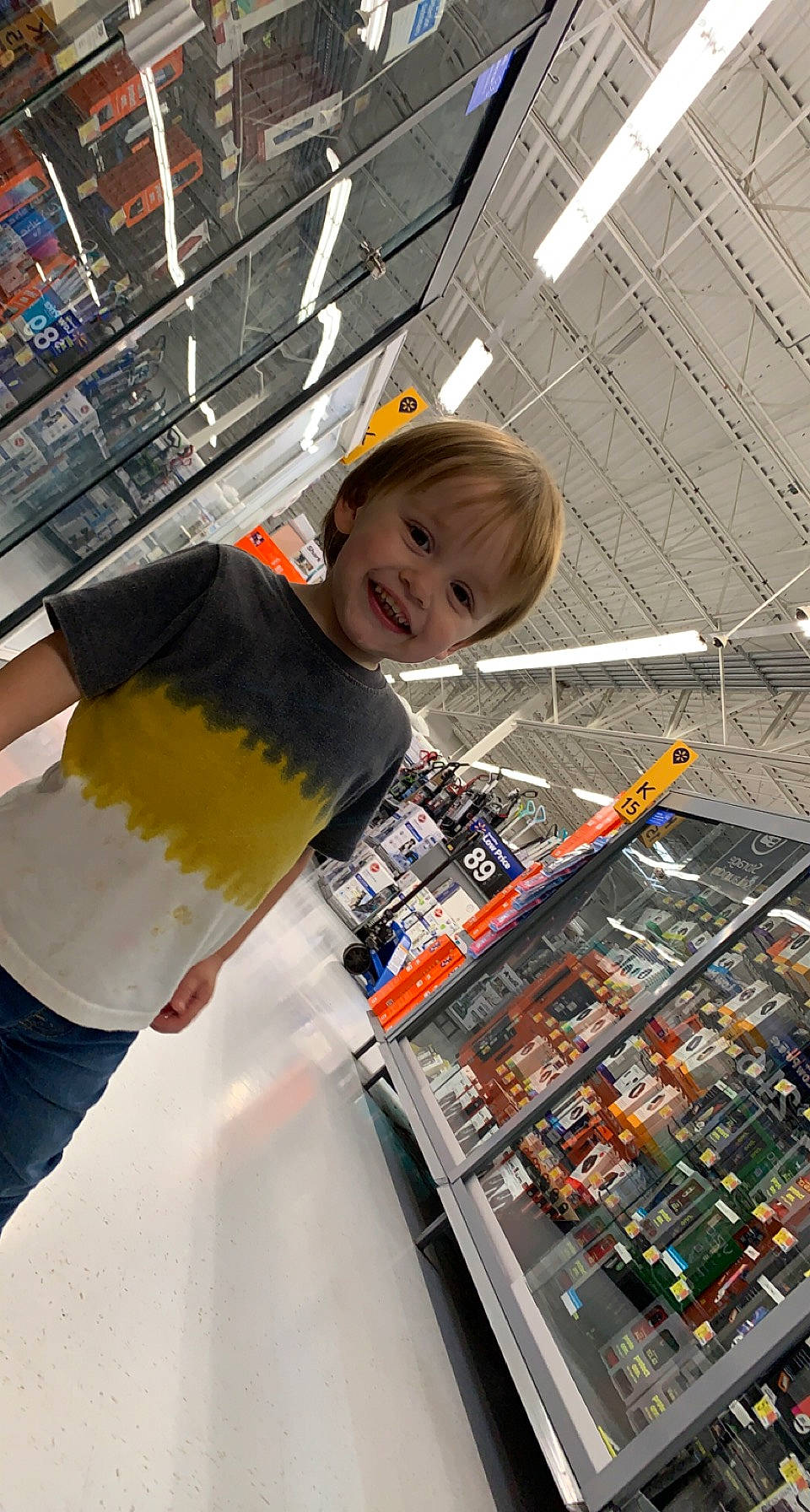 Dallas is registered to the contest to win money with this photo: child, city, convenience_store, customer, design, engineering, fun, glass, joy, leisure, person, public_space, recreation, retail, shopping, smile, t_shirt, toddler, transport