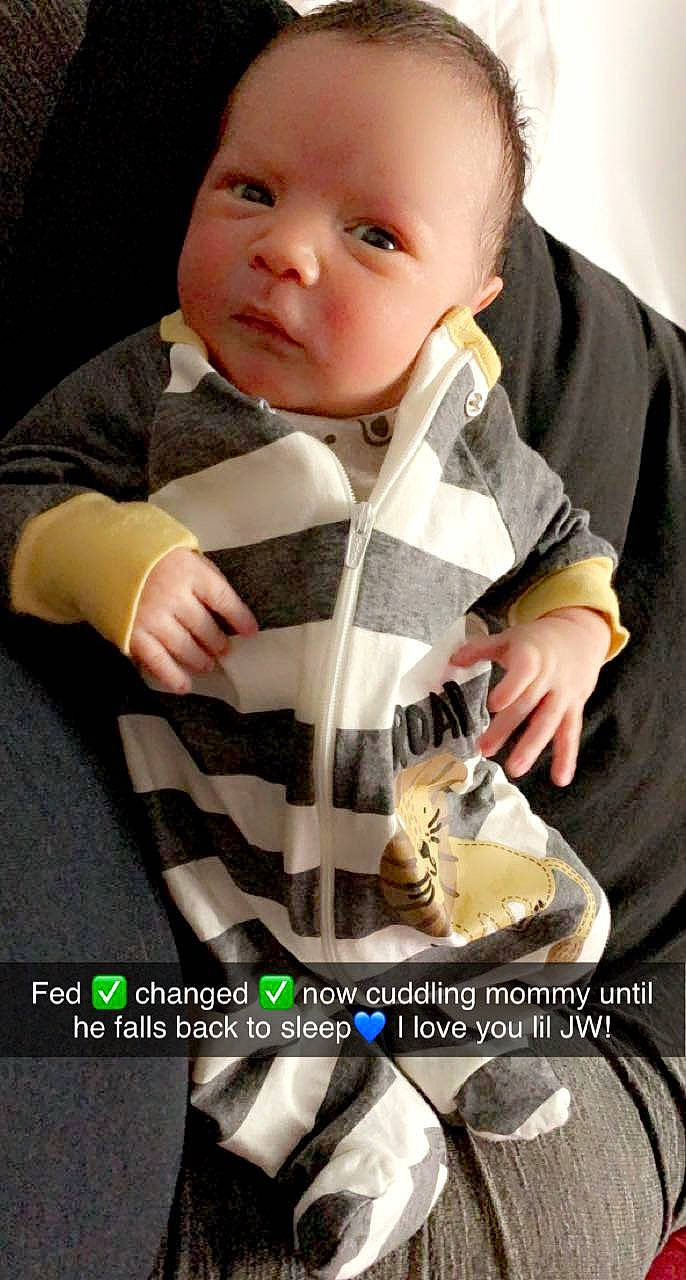 John is registered to the contest to win money with this photo: baby, baby_products, baby_toddler_clothing, cheek, child, collar, cool, finger, hand, mouth, nail, pattern, person, personal_protective_equipment, plaid, sitting, sleeve, t_shirt, tartan, thumb
