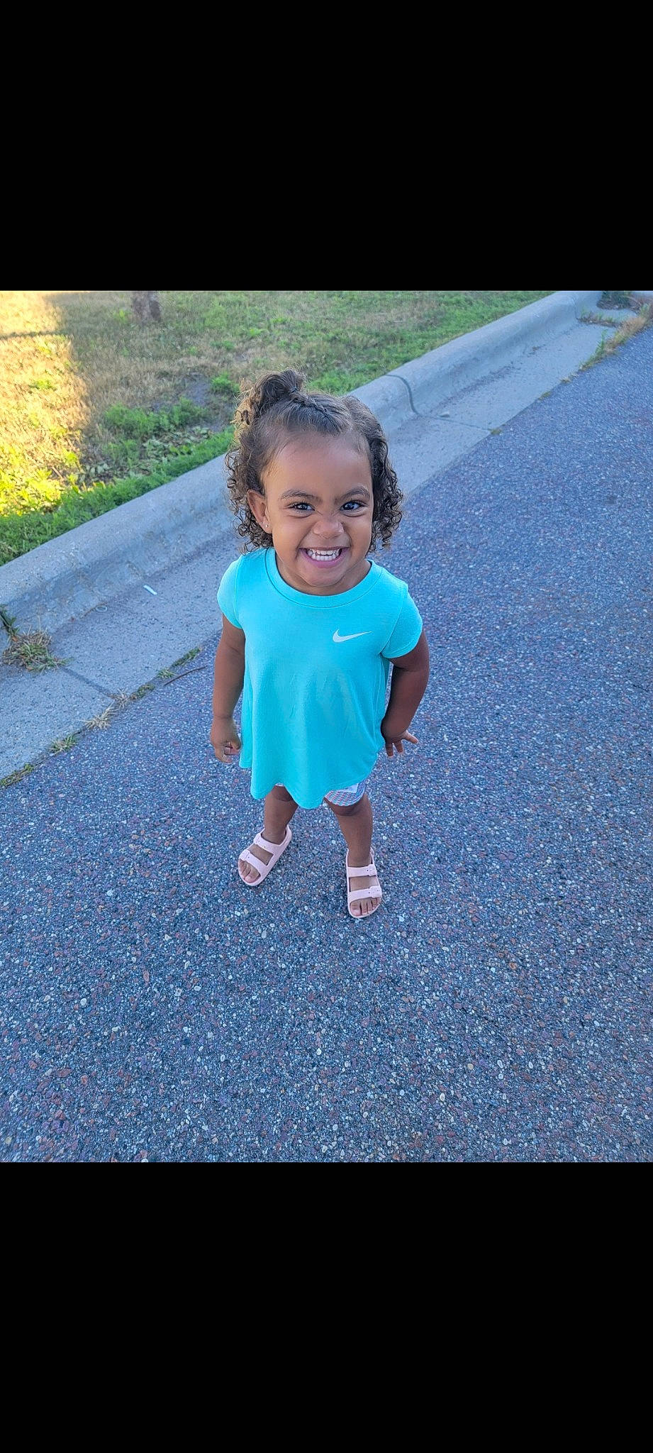 Avayah is registered to the contest to win money with this photo: asphalt, azure, baby_toddler_clothing, child, electric_blue, fun, gesture, grass, happy, joy, leisure, people_in_nature, person, plant, recreation, road, road_surface, sidewalk, smile, tar