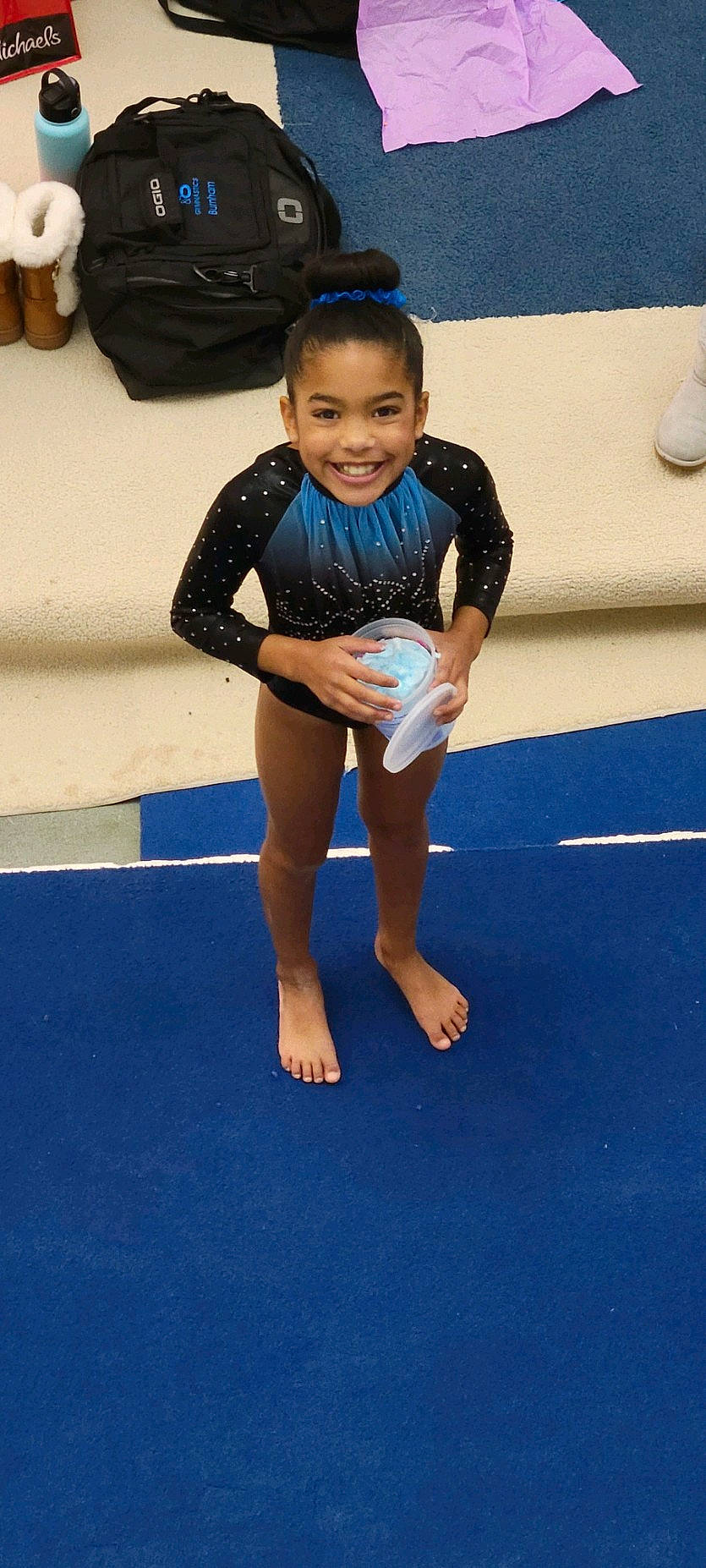 Amiyah is registered to the contest to win money with this photo: artistic_gymnastics, balance, barefoot, competition, competition_event, electric_blue, event, face, flooring, fun, gymnastics, head, joy, knee, performing_arts, person, smile, sports, sportswear, t_shirt