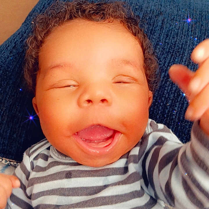 Noah joined the competition — help win amazing prizes! baby, bodypart, clothing, couch, cushion, face, finger, furniture, hand, happy, head, homedecor, laughing, mouth, newborn, person, photography, portrait, smile, t_shirt