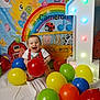 baby, balloon, birthday, banner, colorful, smiling, child, red, yellow, green, blue, orange, white, number_one, celebration, sun, rainbow, school_bus, animal_cartoon, happy