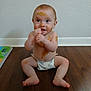 baby, child, diaper, messy, floor, wooden_floor, face, blue_eyes, sitting, curious, indoor, skin, smile, playful, brown_substance, young_child, infant, cute, bare_chest, background_wall