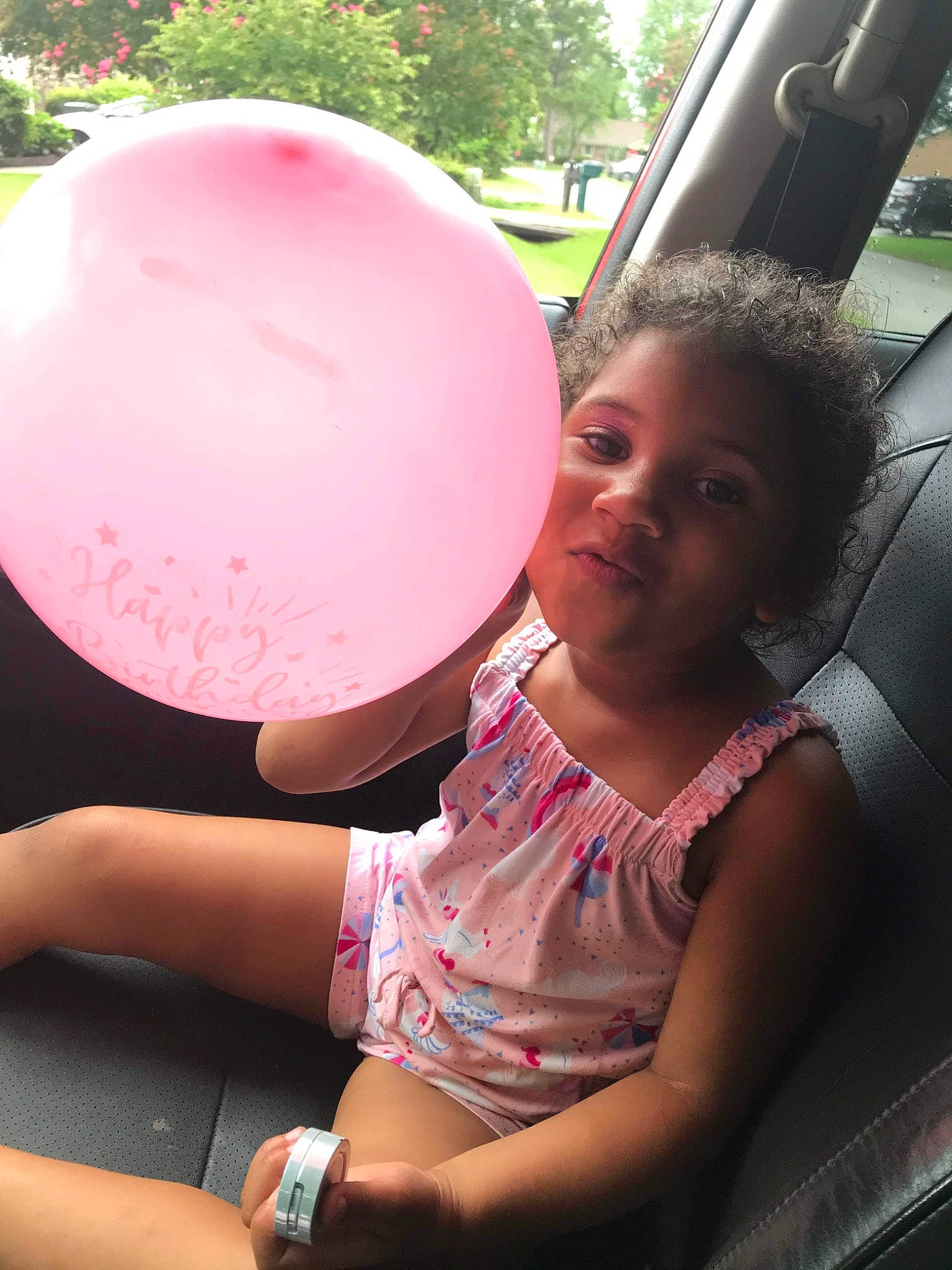 Kaydence is registered to the contest to win money with this photo: balloon, child, cool, event, facial_expression, finger, fun, hairstyle, happy, human_leg, leisure, magenta, party_supply, person, pink, snapshot, summer, t_shirt, thigh, toddler