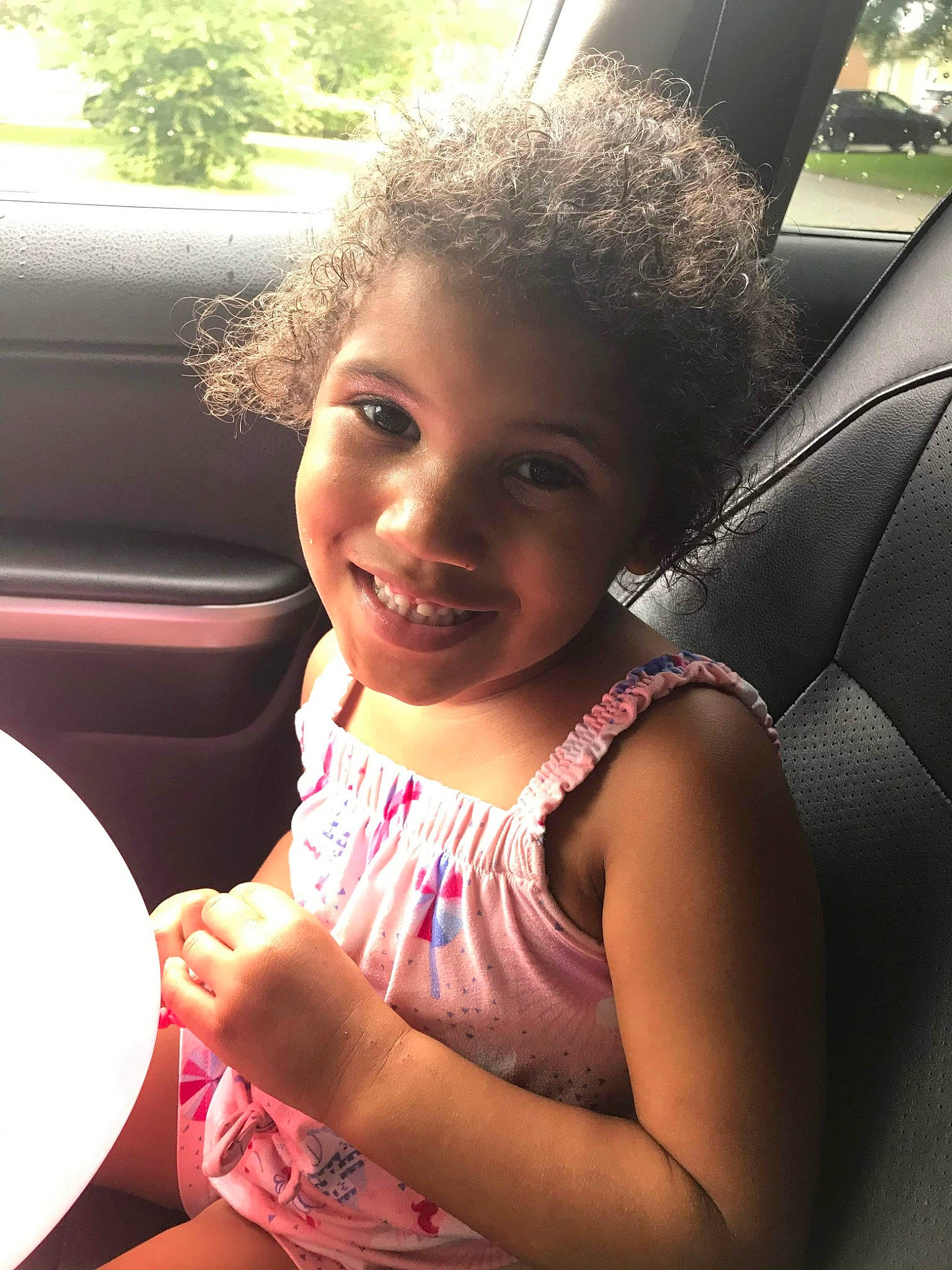 Kaydence is registered to the contest to win money with this photo: car, child, cool, dress, face, facial_expression, finger, fun, hairstyle, happy, joy, morning, people, person, skin, smile, summer, tints_and_shades, toddler, vehicle