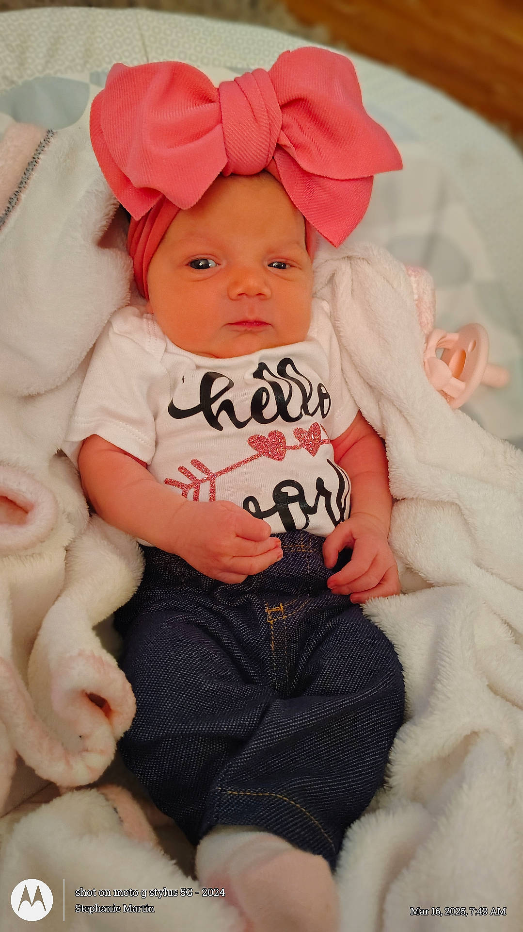 baby, bed, bodypart, bonnet, clothing, couch, crib, face, finger, furniture, hand, hat, head, infantbed, jeans, newborn, pants, person, photography, portrait