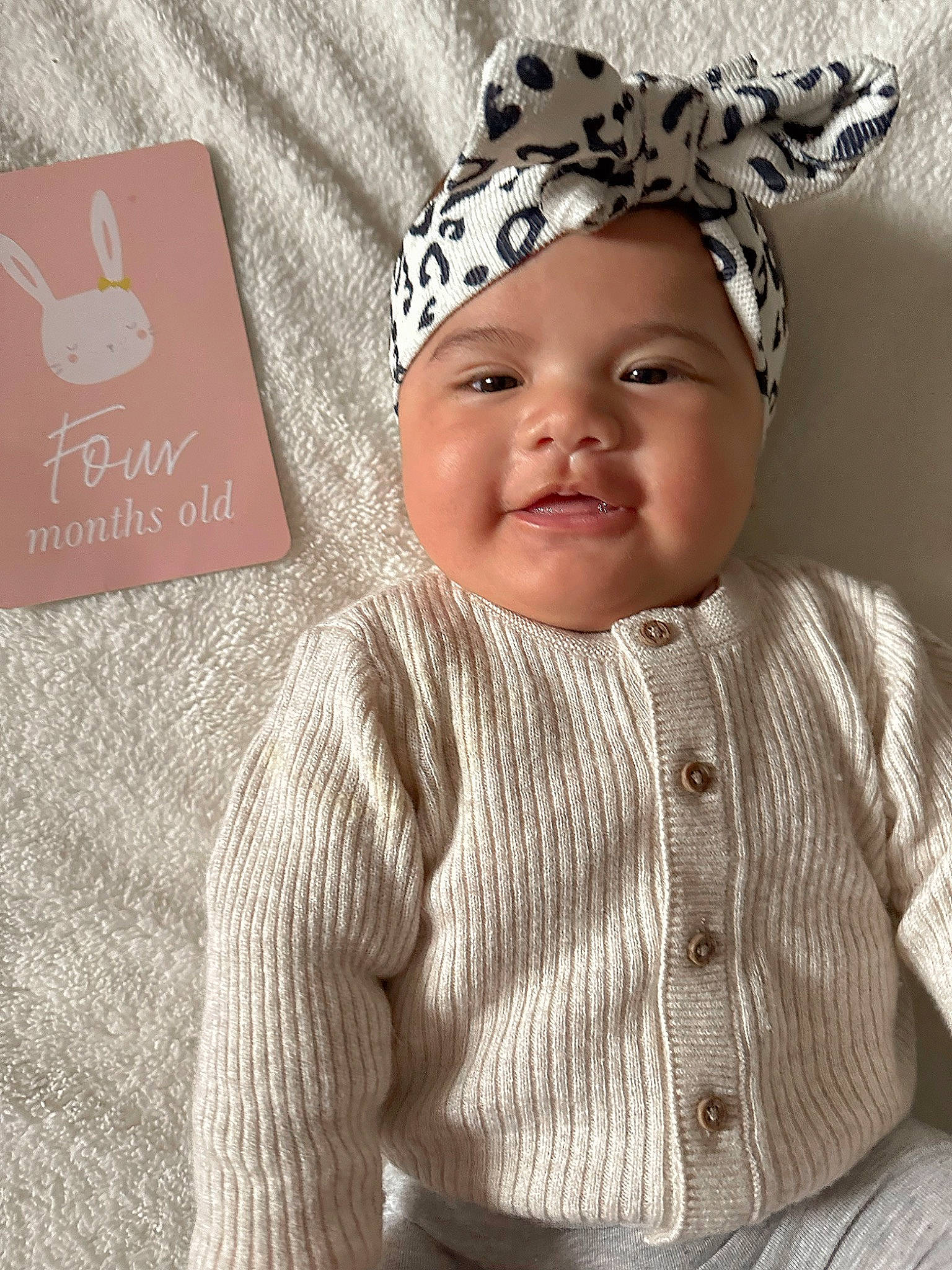 Leila joined the competition — help win amazing prizes! baby, baby_toddler_clothing, cap, cool, costume_hat, facial_expression, happy, headgear, headwear, knit_cap, organ, outerwear, pattern, person, pink, skin, sleeve, smile, t_shirt, textile