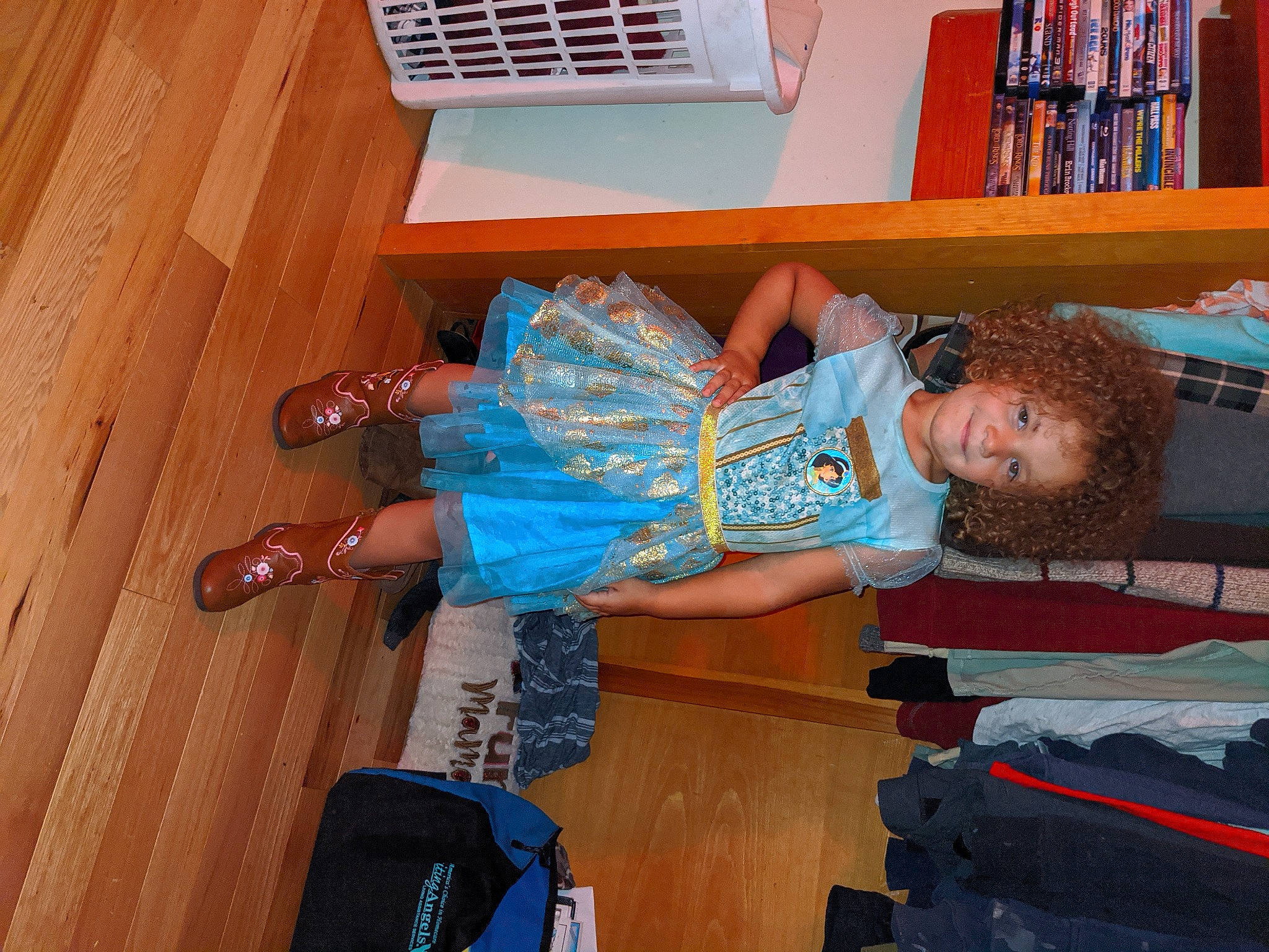 Paisley joined the competition — help win amazing prizes! blue, bookcase, comfort, denim, electric_blue, flooring, fun, hardwood, human_leg, joy, leisure, person, room, shelf, shelving, sneakers, t_shirt, thigh, toddler, varnish