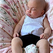 Arisa is registered to the contest to win money with this photo: baby, sleeping, blanket, floral_pattern, white_top, black_shorts, infant, peaceful, soft_texture, cute, resting, child, small_hands, chubby_legs, indoors, portrait, relaxation, comfort, nap, closeup