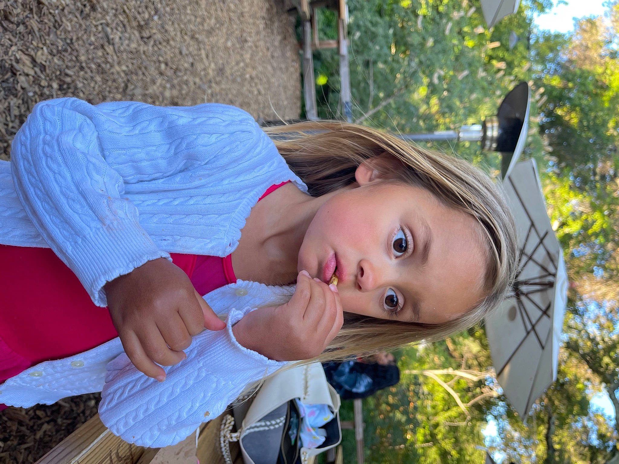 Charlotte is registered to the contest to win money with this photo: bangs, brown_hair, child, costume, dress, electric_blue, eyewear, fun, grass, happy, leisure, long_hair, person, photo_shoot, plant, recreation, sitting, street_fashion, toy, tree