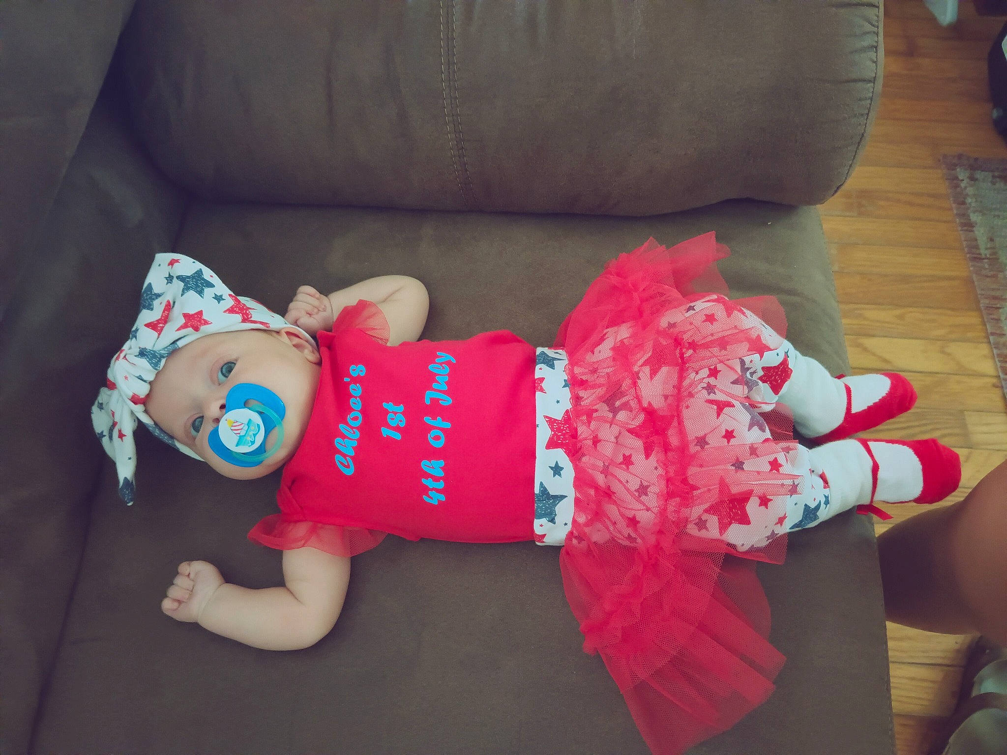 Chloee is registered to the contest to win money with this photo: baby_products, baby_toddler_clothing, child, comfort, couch, doll, dress, headgear, human_leg, lap, pattern, person, room, sleeve, sock, stuffed_toy, textile, thigh, toy, wood