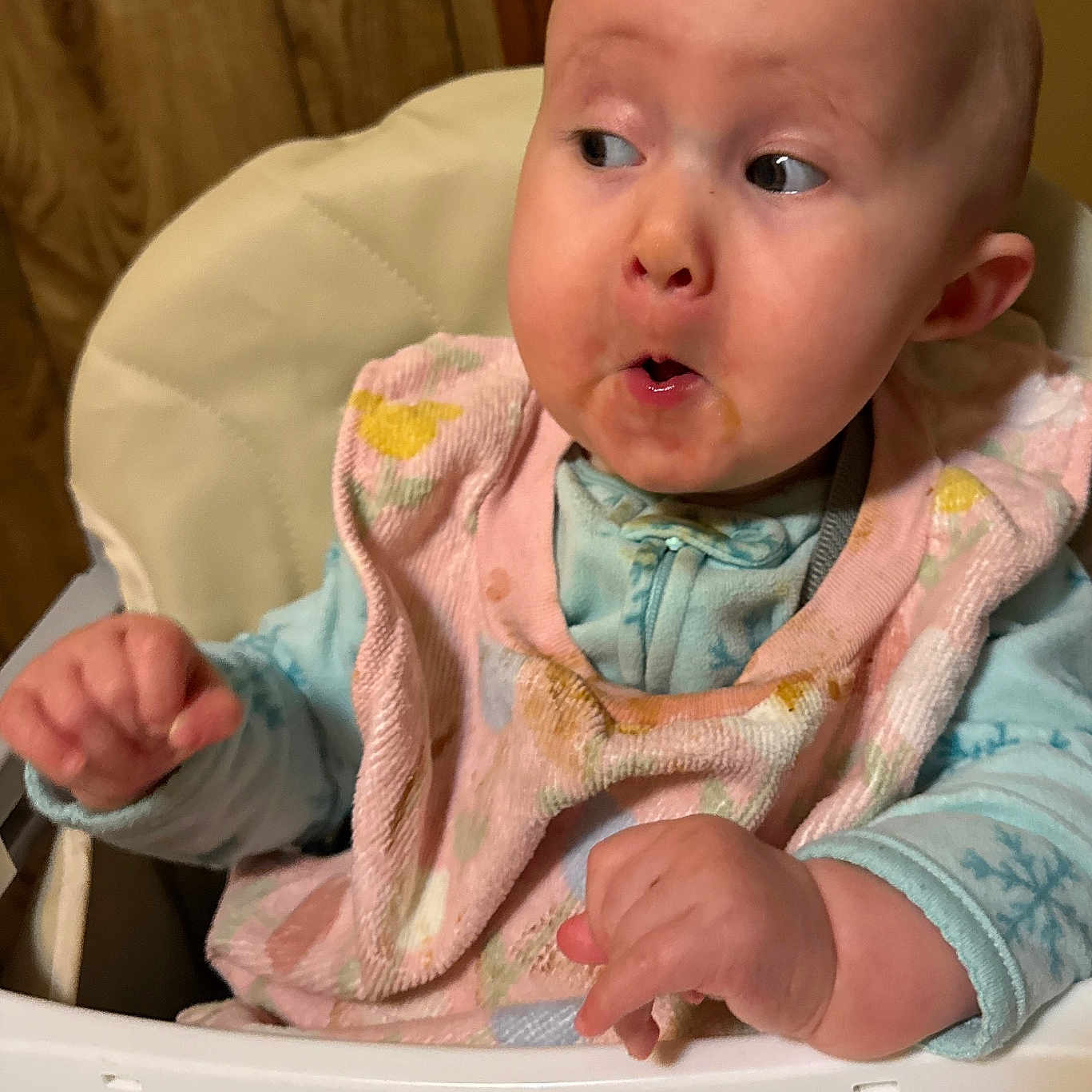 Amelia joined the competition — help win amazing prizes! baby, bib, child, clothing, curious, cute, expression, face, hand, head, high_chair, indoor, infant, pajamas, person, seat, skin, surprised, wooden_door, young