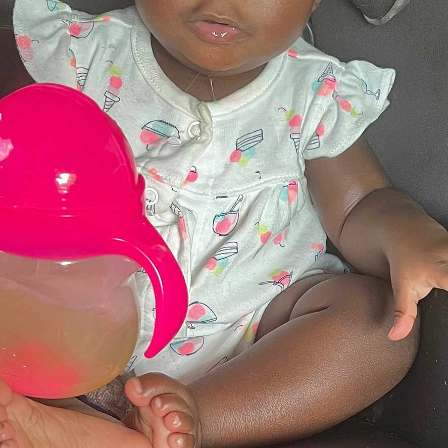 Mulan joined the competition — help win amazing prizes! baby, barefoot, car_seat, cherry_pattern, child, curly_hair, cute, eyes, face, hand, ice_cream_pattern, indoors, person, pink, seat_belt, sippy_cup, skin, toddler, white_clothing, young_child