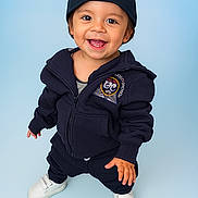 Omar joined the competition — help win amazing prizes! toddler, child, smiling, happy, baseball_cap, hoodie, navy_blue, white_shoes, standing, studio_background, cute, casual_clothing, portrait, young_child, fashion, playful, expression, person, footwear, indoor