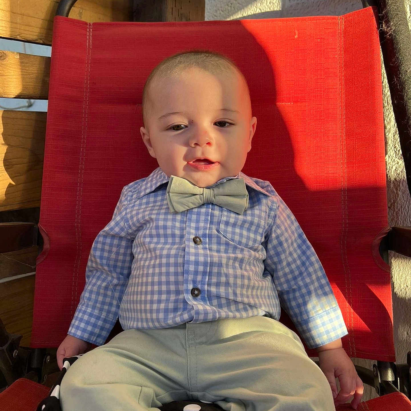 Tristan joined the competition — help win amazing prizes! baby, baby_boy, bow_tie, casual, checkered_shirt, child, clothing, cute, fashion, indoor, infant, pants, person, portrait, red_chair, relaxed, seat, shadow, smile, sunlight